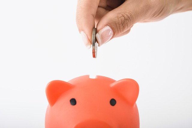 dropping a coin into a piggy bank
