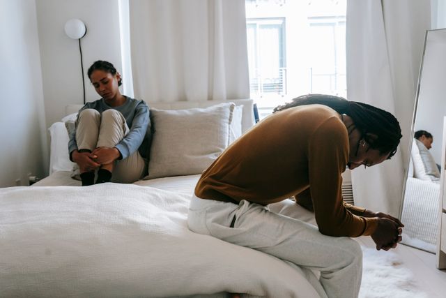 couple arguing on bed
