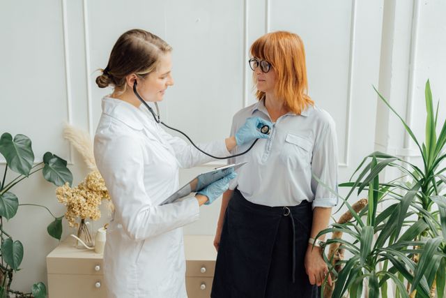 woman getting checked by dr at home