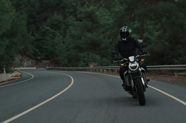 man riding motorcycle down road