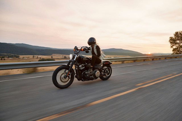 woman riding motorcycle down road