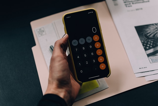 using a calculator figuring out taxes