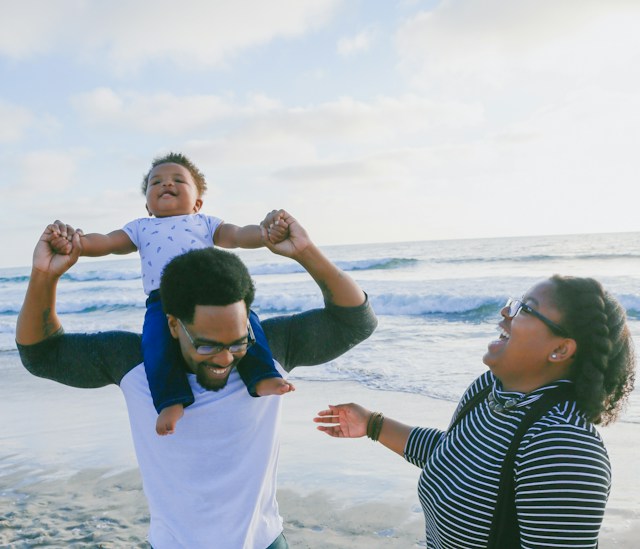 family laughing at the beach