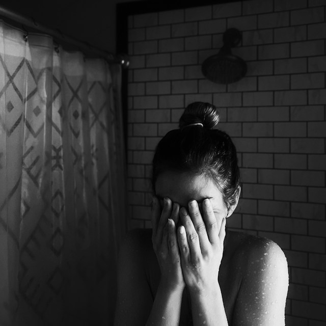 woman crying in shower